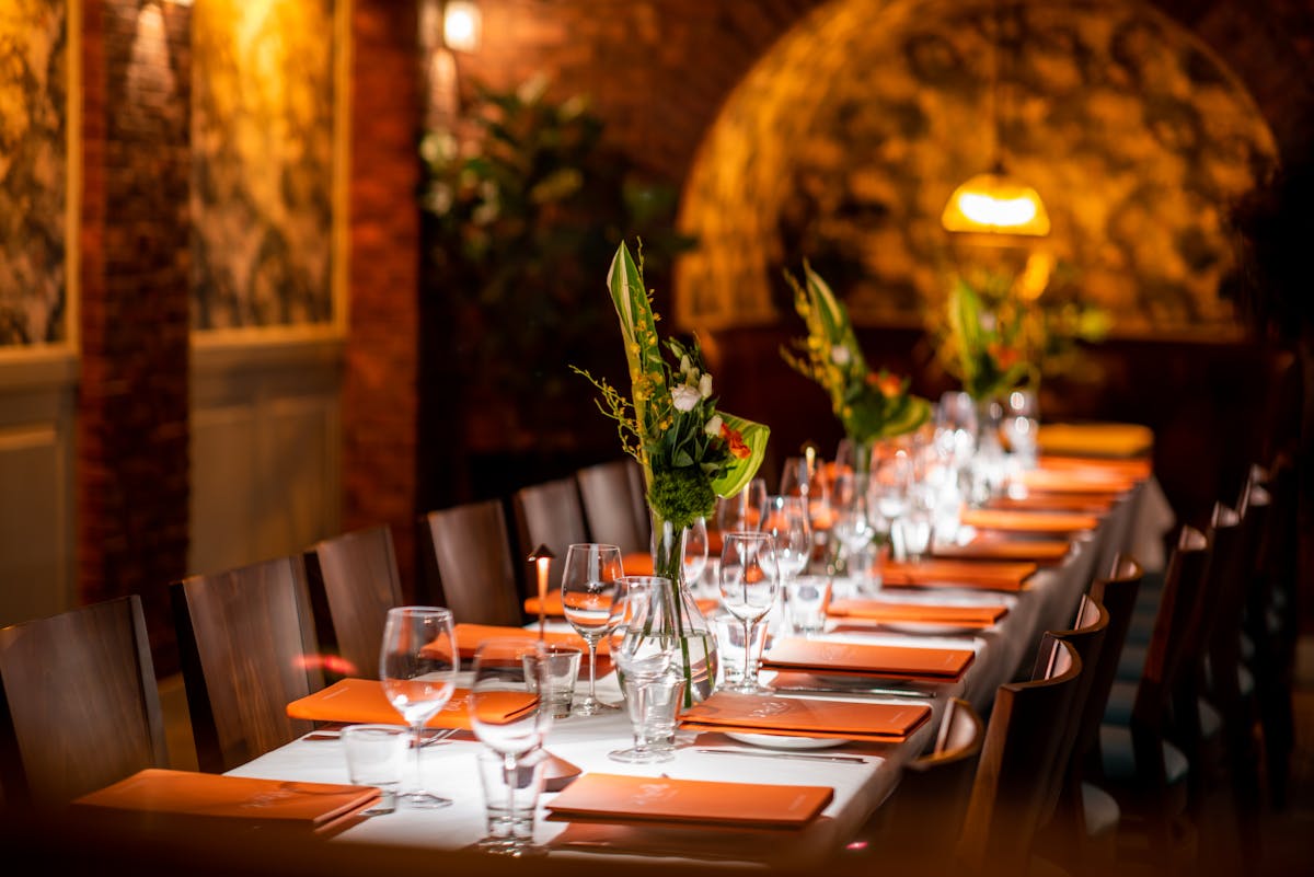 A long candlelit table set for a group in Sonsie’s dining room.